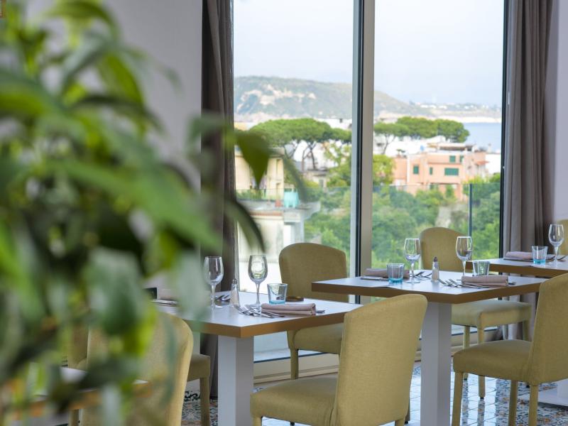 Elegant restaurant with panoramic view and modern furnishings.