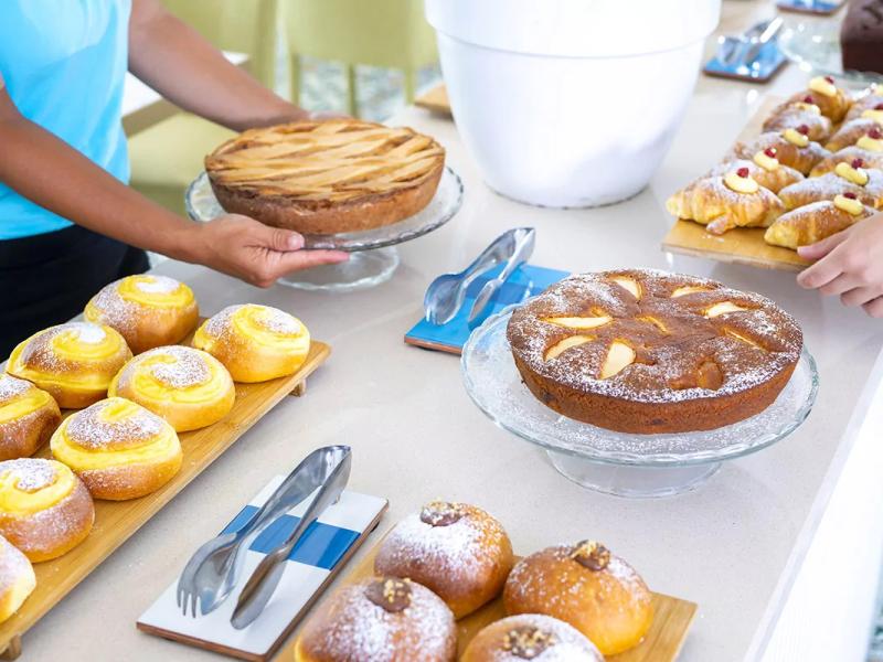 Variety of desserts on a table, including cakes and pastries.