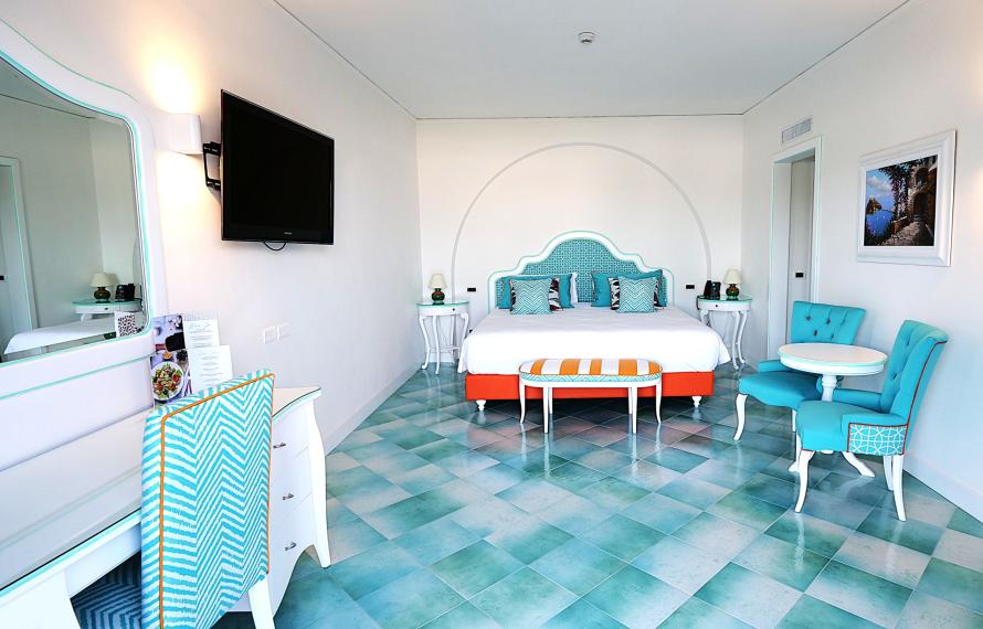 Bright room with colorful furnishings and tiled floor.